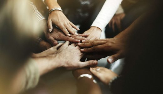 closeup-diverse-people-joining-their-hands-min